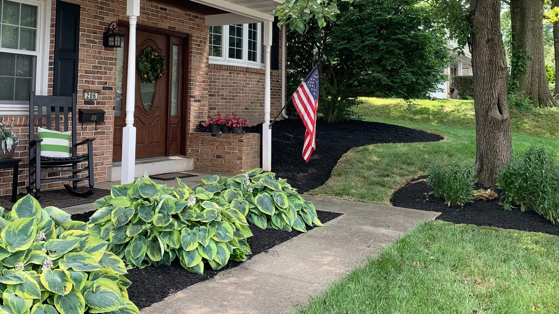 Yard with landscape beds and green grass in Lititz, PA.