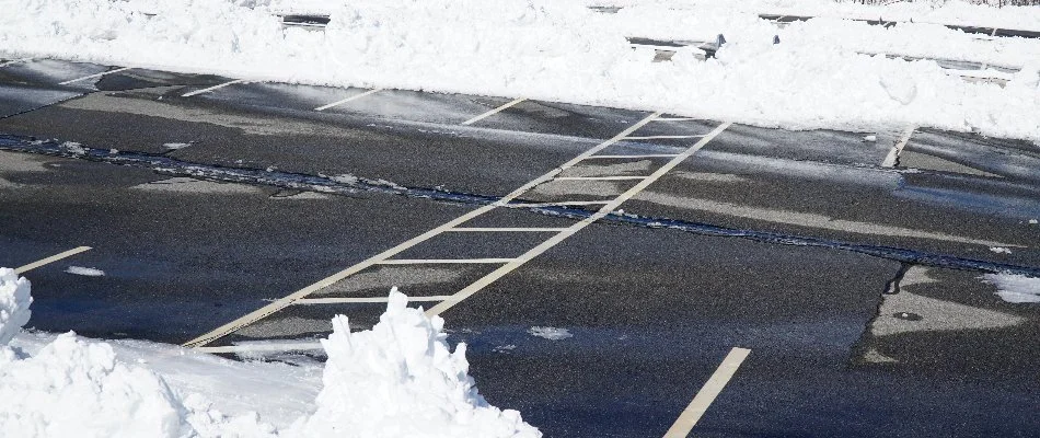 Commercial parking lot with snow pushed to the sides.