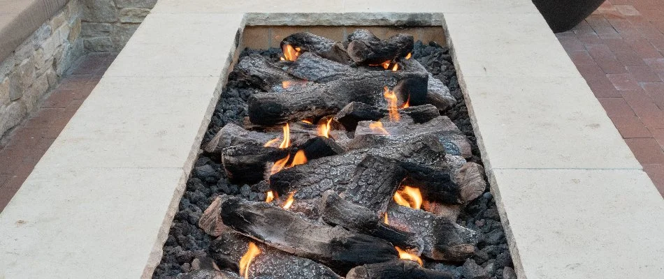 A rectangular fire pit in Lititz, PA, burning wood.