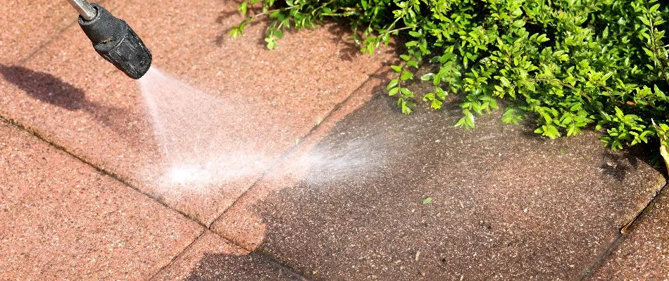 Red patio being washed by a professional.