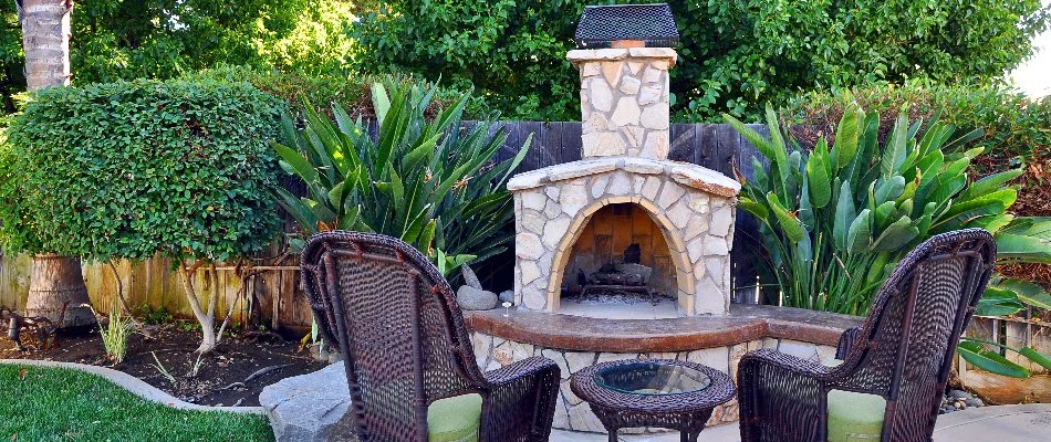 Wood-burning outdoor fireplace with two chairs in front of it in Lititz, PA.