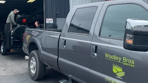 Woolley Bros Lawn Care truck at customer's home in Lancaster, PA.